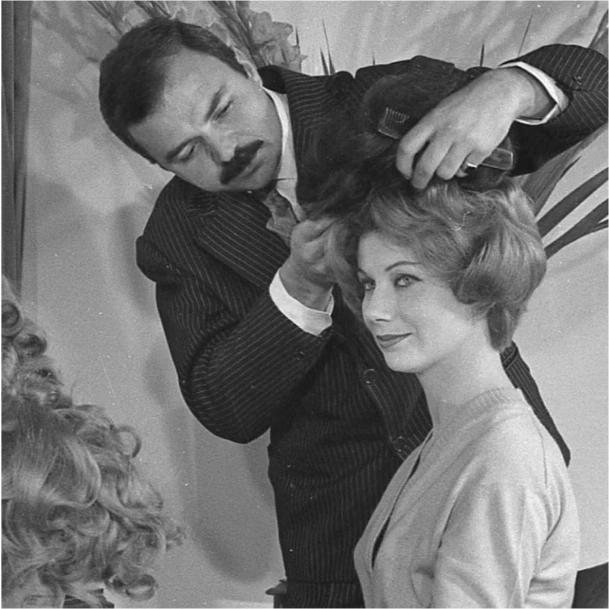 Black-and-white photo of a hairstylist working with a client at Dessange